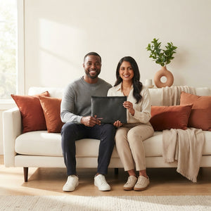 A diverse couple holding a fireproof document bag in a bright modern living room with warm terracotta accents.